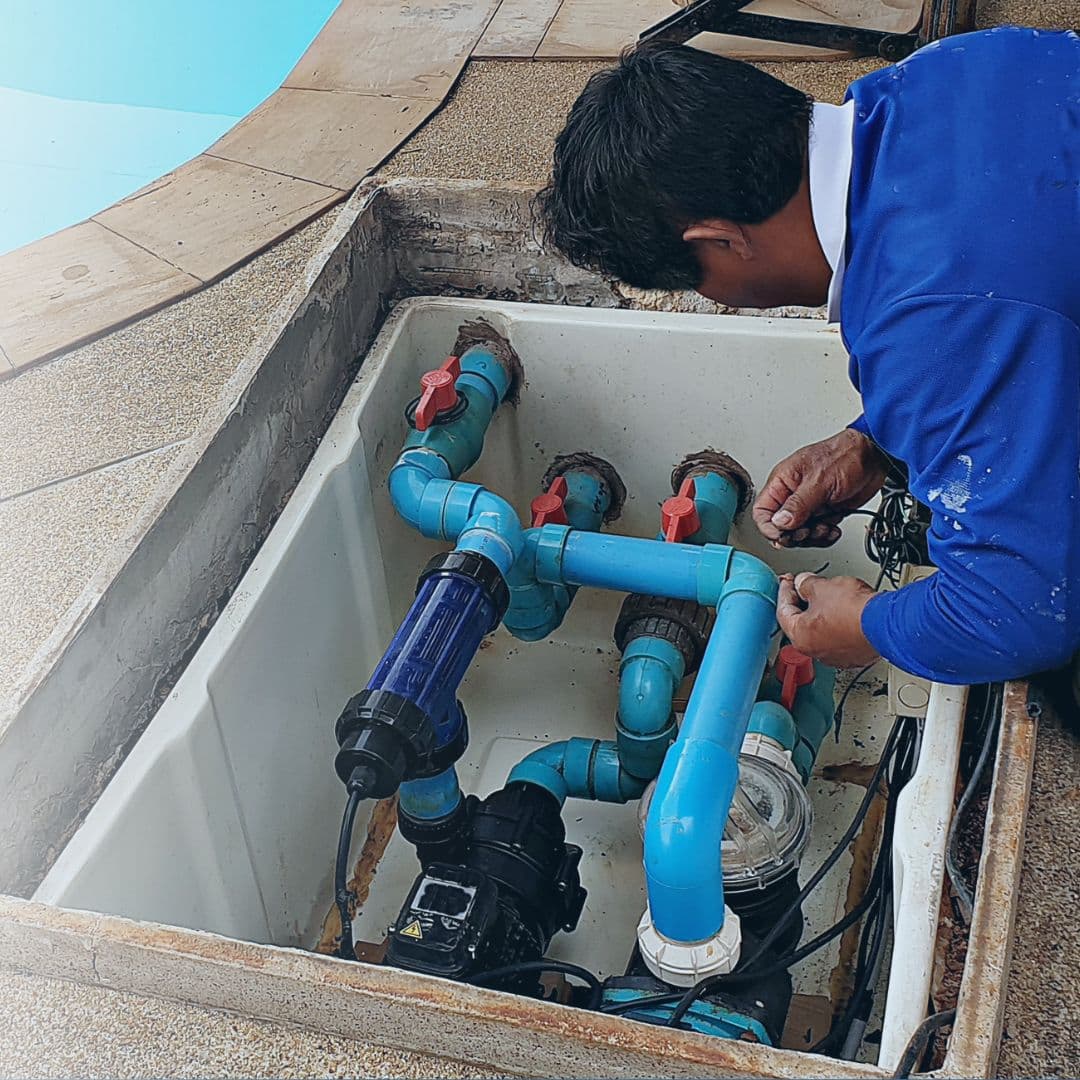 Home inspector checking a worn pool pump and filter system during an NC pool inspection